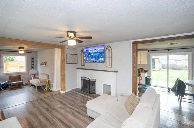 a living room with furniture two window and a fireplace