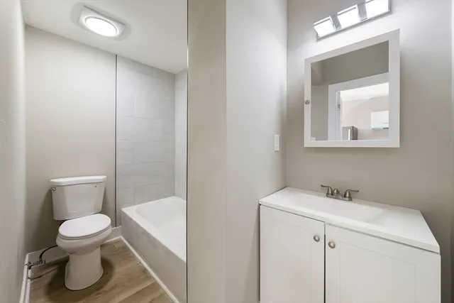 a white toilet sitting next to a bathroom sink
