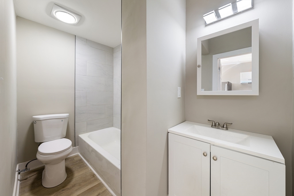 50 Common Street, Unit 5 Lawrence, MA 01840 - Photo 12 of 28 a white toilet sitting next to a bathroom sink