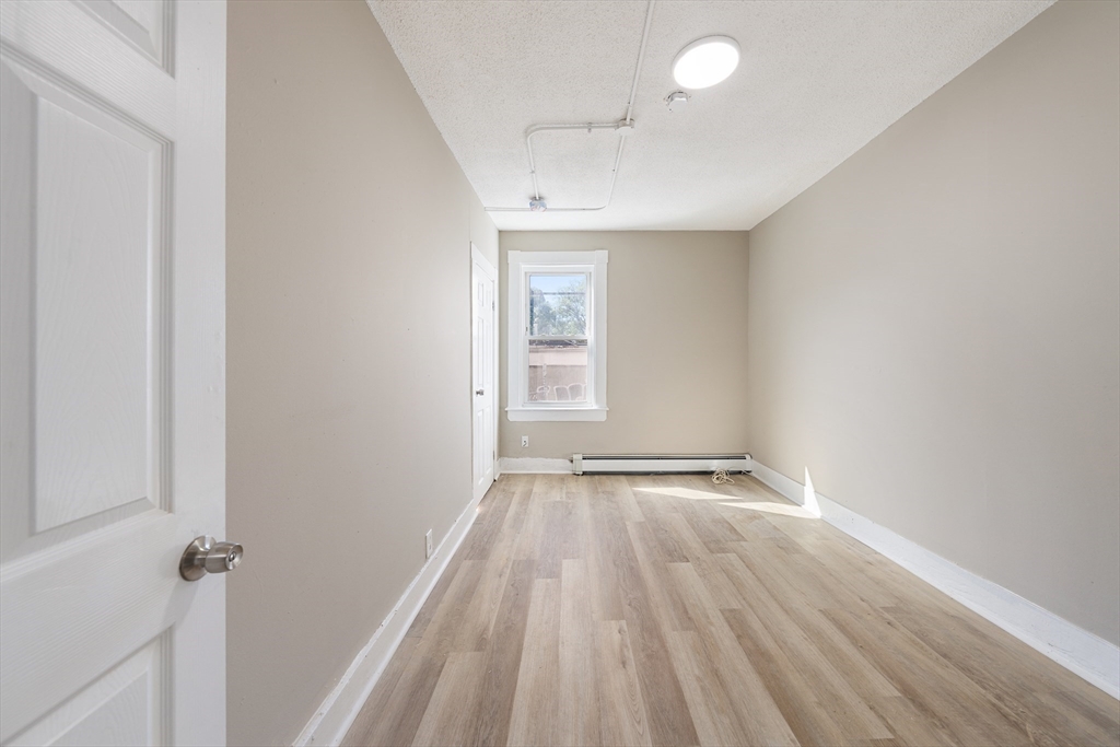50 Common Street, Unit 5 Lawrence, MA 01840 - Photo 15 of 28 wooden floor in an empty room with a window