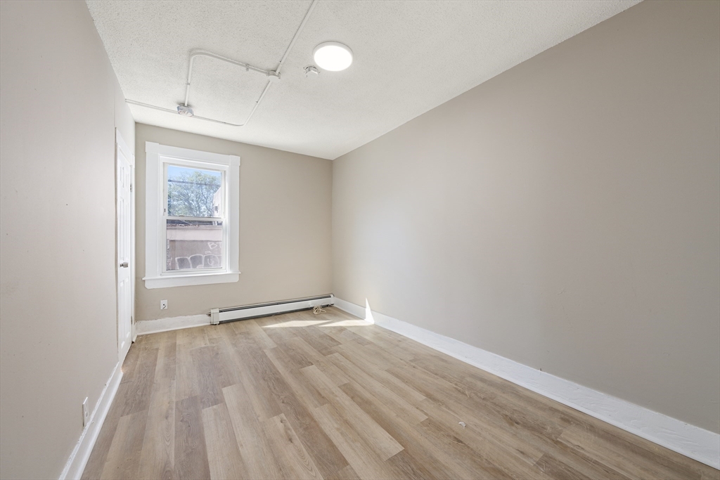 50 Common Street, Unit 5 Lawrence, MA 01840 - Photo 16 of 28 a view of an empty room with wooden floor and a window