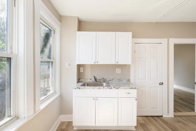 a bathroom with a sink vanity granite tub and shower