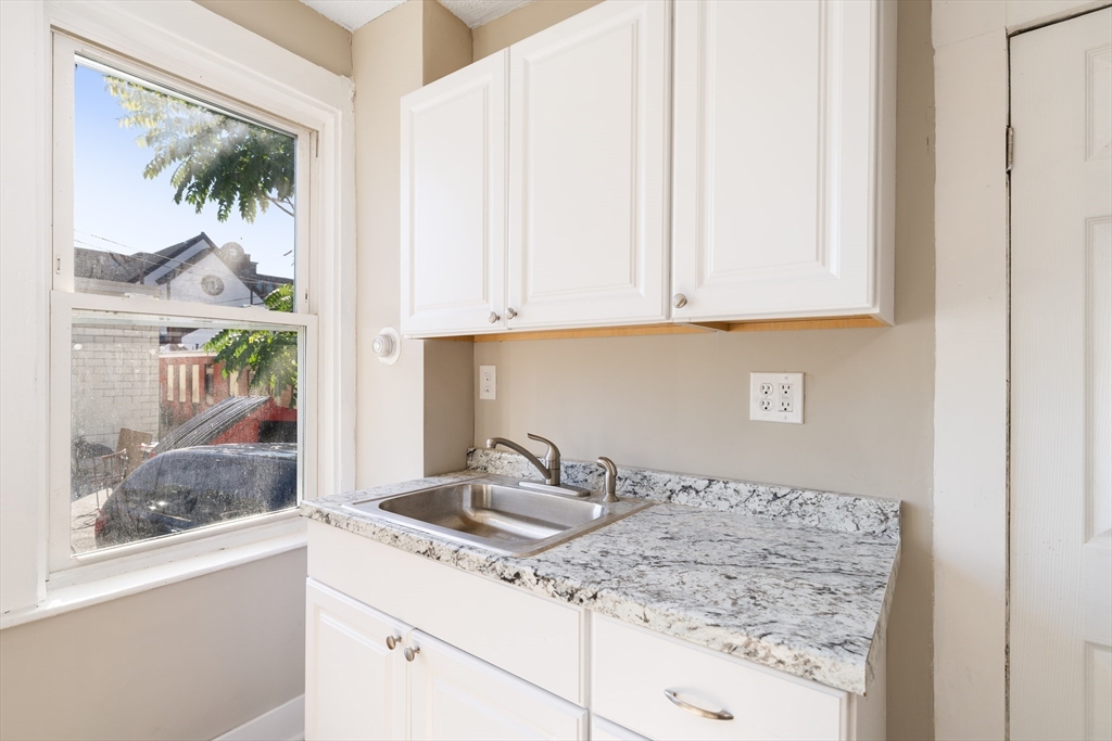 50 Common Street, Unit 5 Lawrence, MA 01840 - Photo 21 of 28 a kitchen with a sink and cabinets