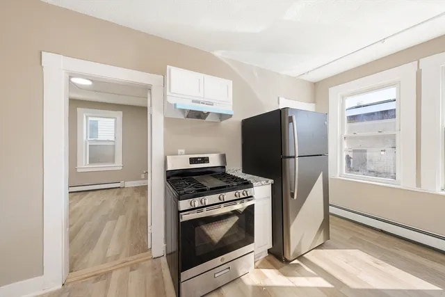 a kitchen with a stove a refrigerator and a sink