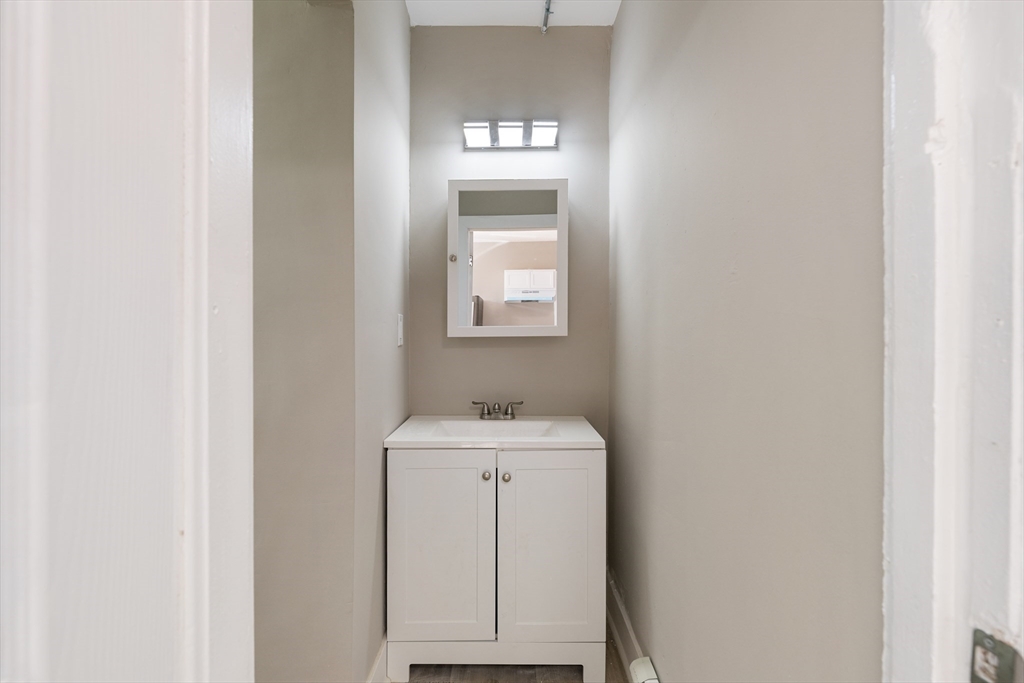 50 Common Street, Unit 5 Lawrence, MA 01840 - Photo 10 of 28 a bathroom with a sink and a mirror