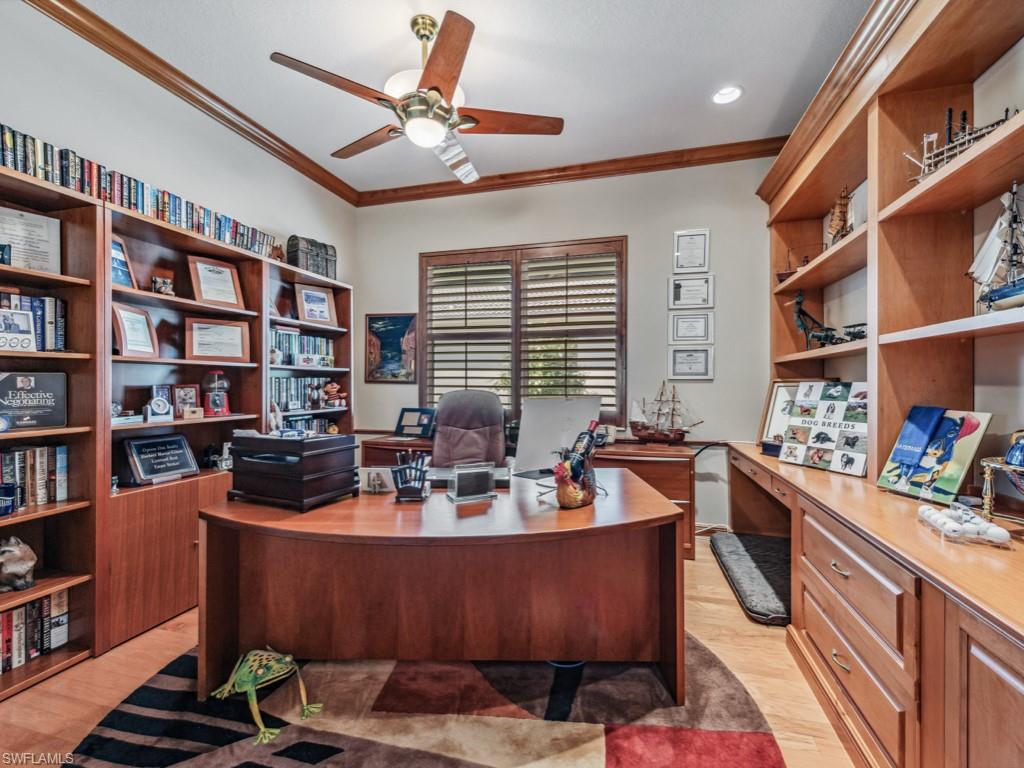 6048 Fairway Court Naples, FL 34110 - Photo 16 of 49 a living room with furniture window and book shelf