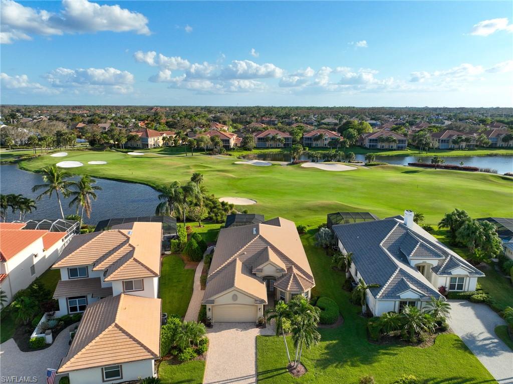6048 Fairway Court Naples, FL 34110 - Photo 22 of 49 an aerial view of a house with a garden and lake view