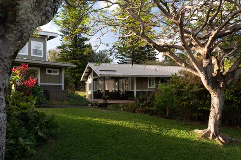 a front view of a house with a garden