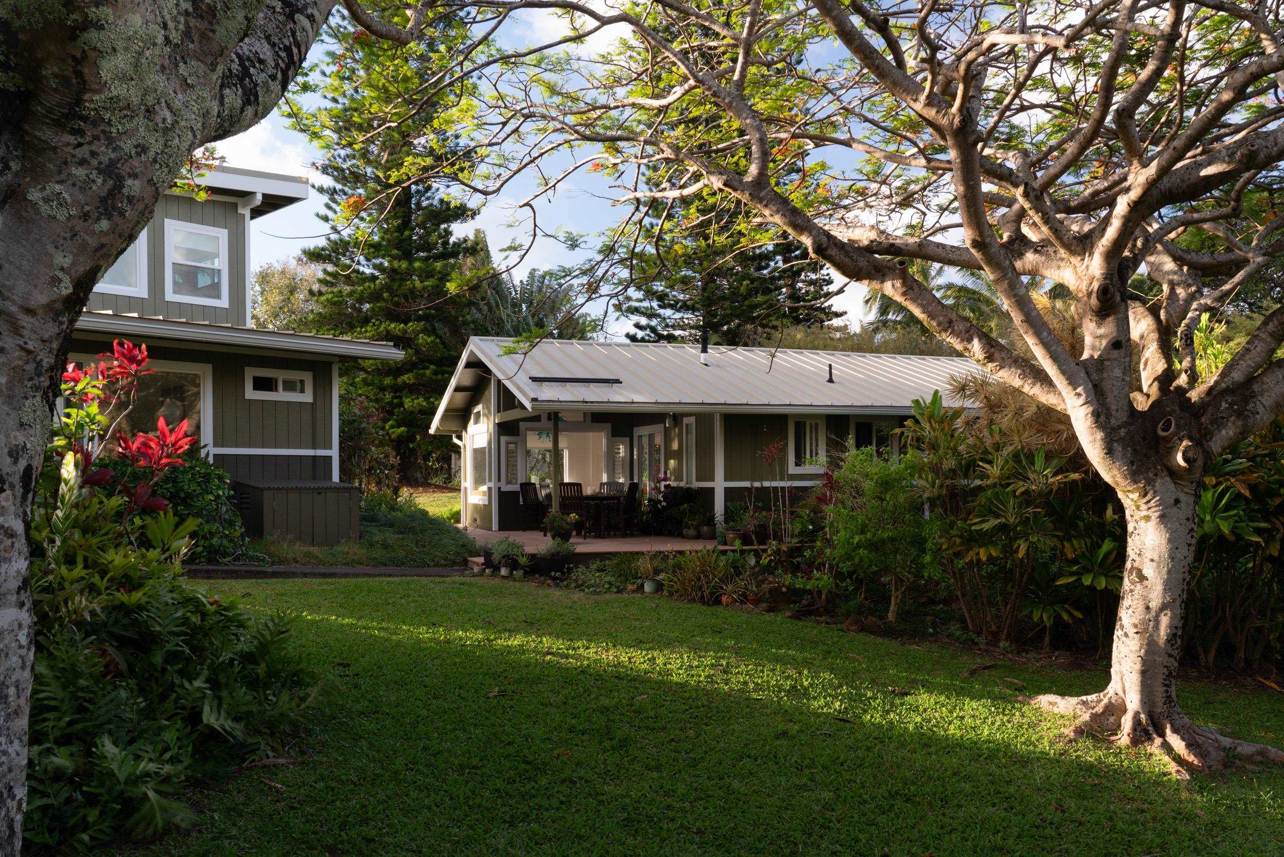 a front view of a house with a garden