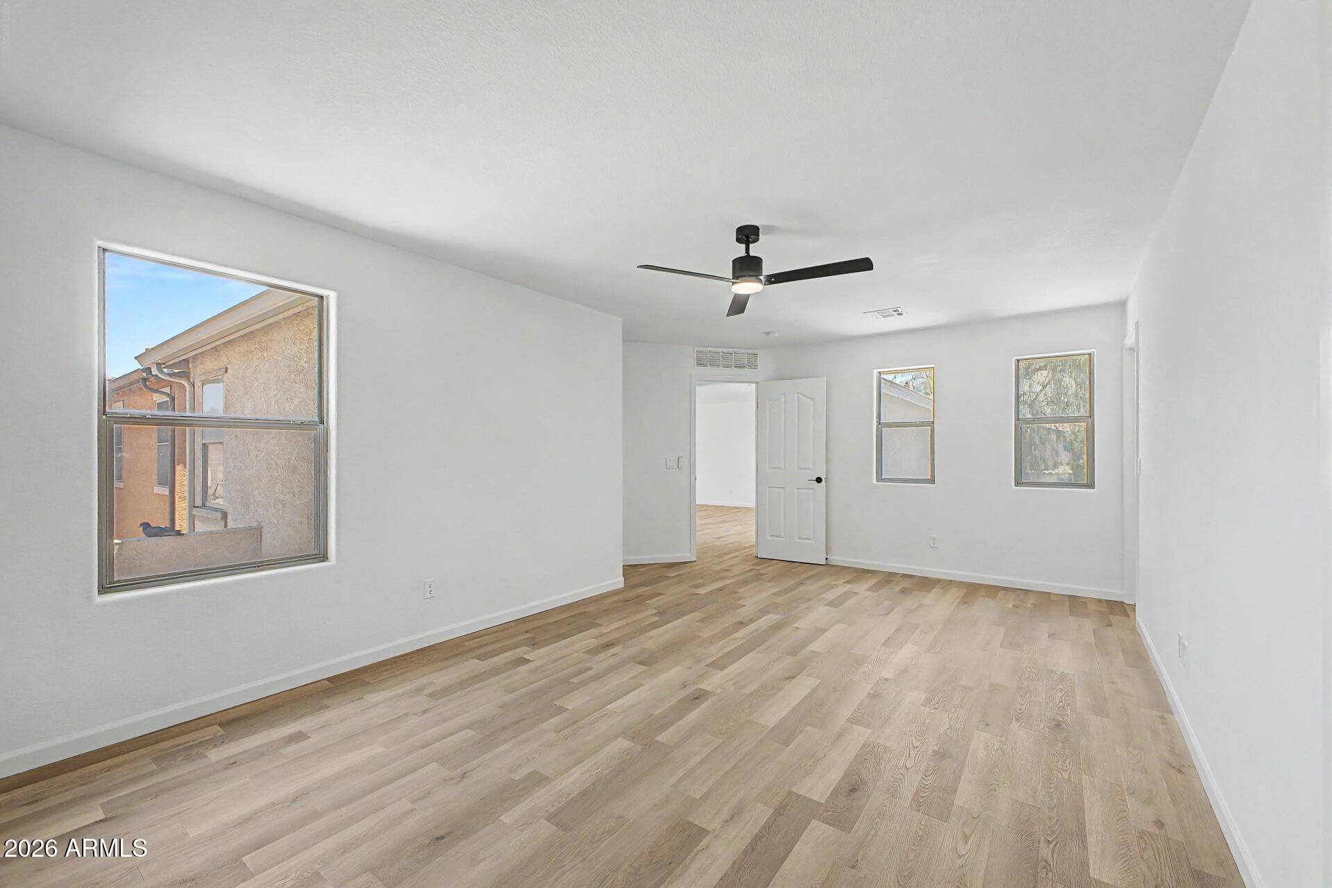 6452 West Ruth Avenue Glendale, AZ 85302 - Photo 22 of 35 a view of empty room with wooden floor and fan