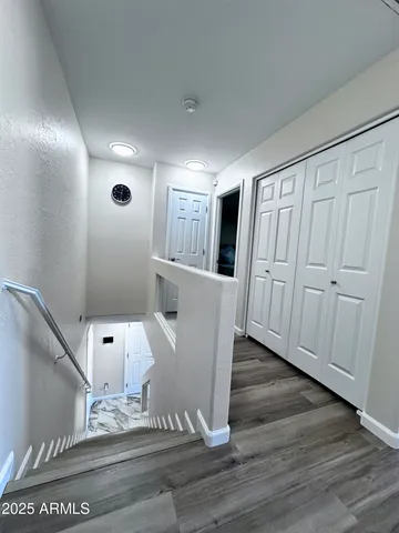 a bedroom with bed and wooden floor