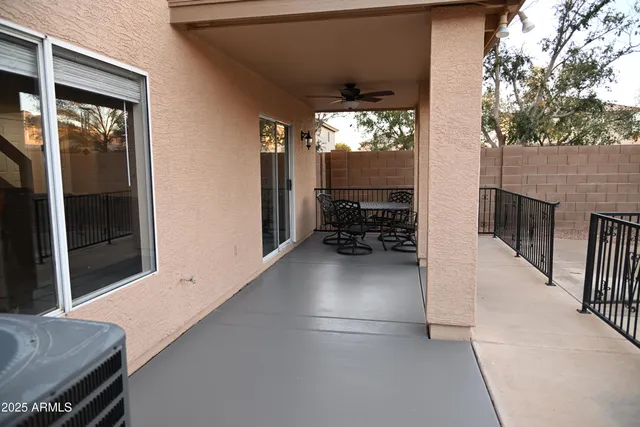 a backyard of a house with table and chairs