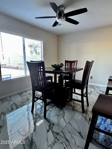 a view of a dining room with furniture and a window