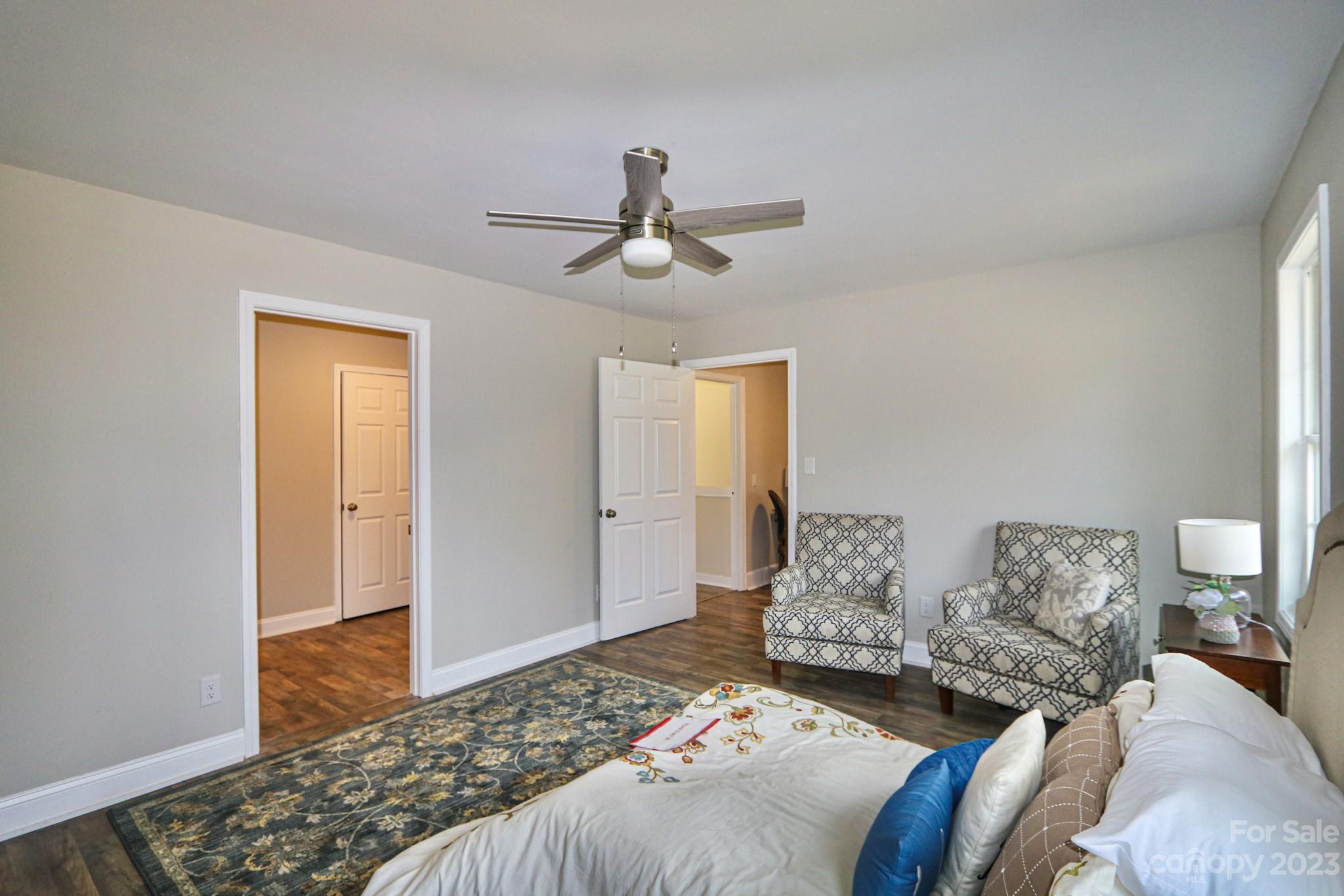219 Harris Avenue Elkin, NC 28621 - Photo 14 of 48 a bedroom with a bed and a chandelier
