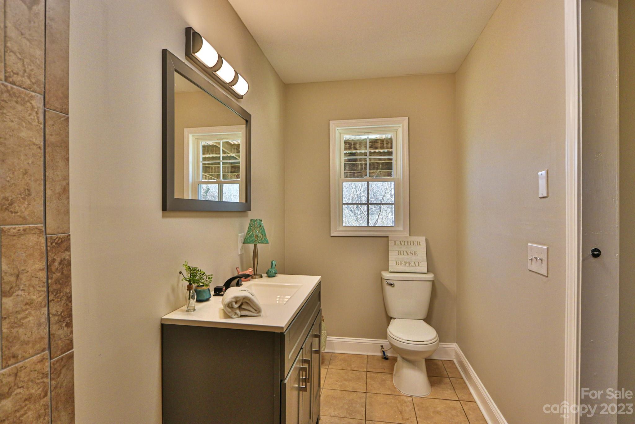 219 Harris Avenue Elkin, NC 28621 - Photo 17 of 48 a bathroom with a toilet sink and mirror