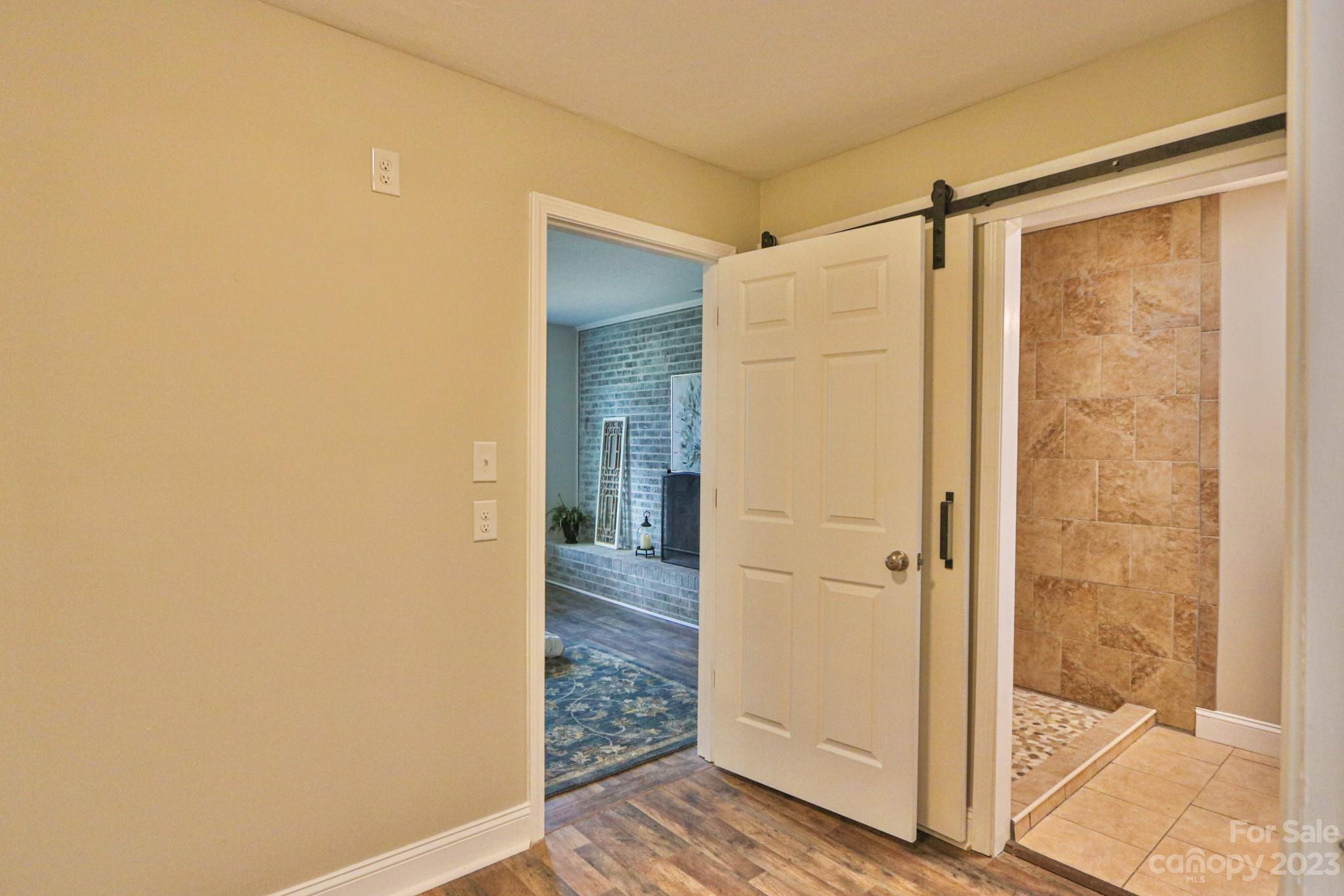 219 Harris Avenue Elkin, NC 28621 - Photo 21 of 48 a bathroom with a glass shower door