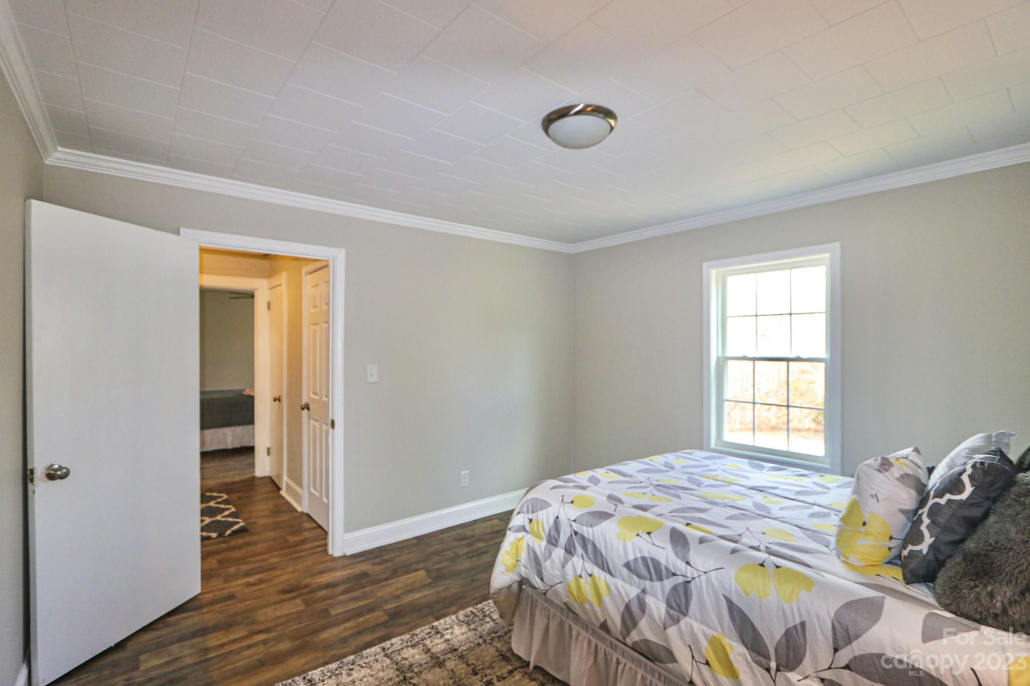 219 Harris Avenue Elkin, NC 28621 - Photo 29 of 48 a bedroom with a bed and wooden floor