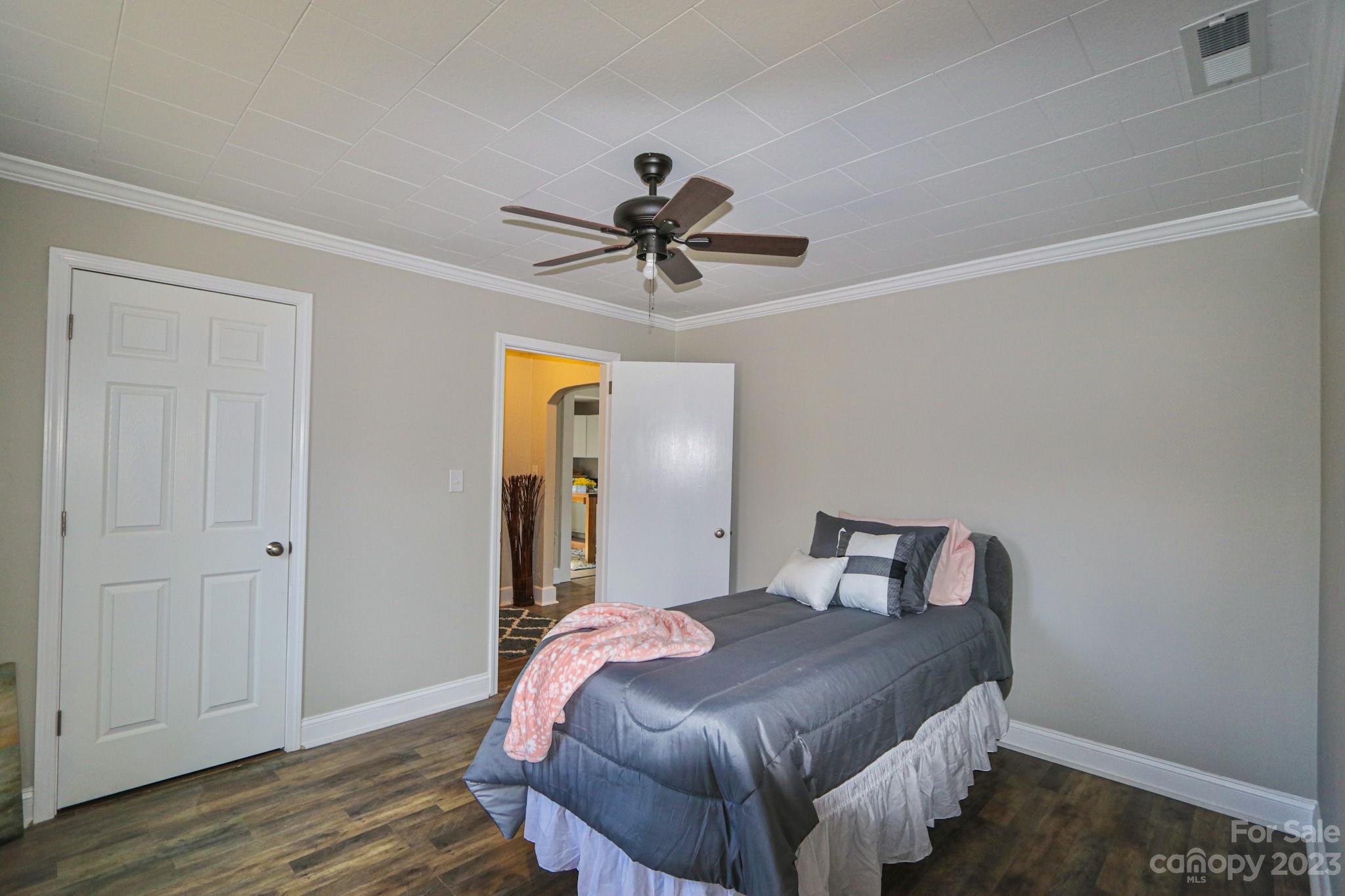 219 Harris Avenue Elkin, NC 28621 - Photo 31 of 48 a bedroom with a bed and a chandelier