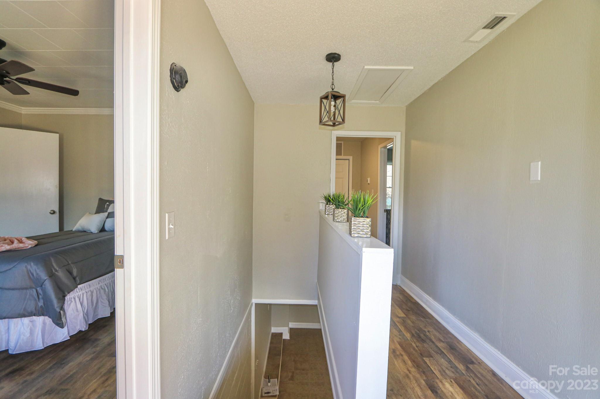 219 Harris Avenue Elkin, NC 28621 - Photo 33 of 48 a view of hallway with furniture and wooden floor