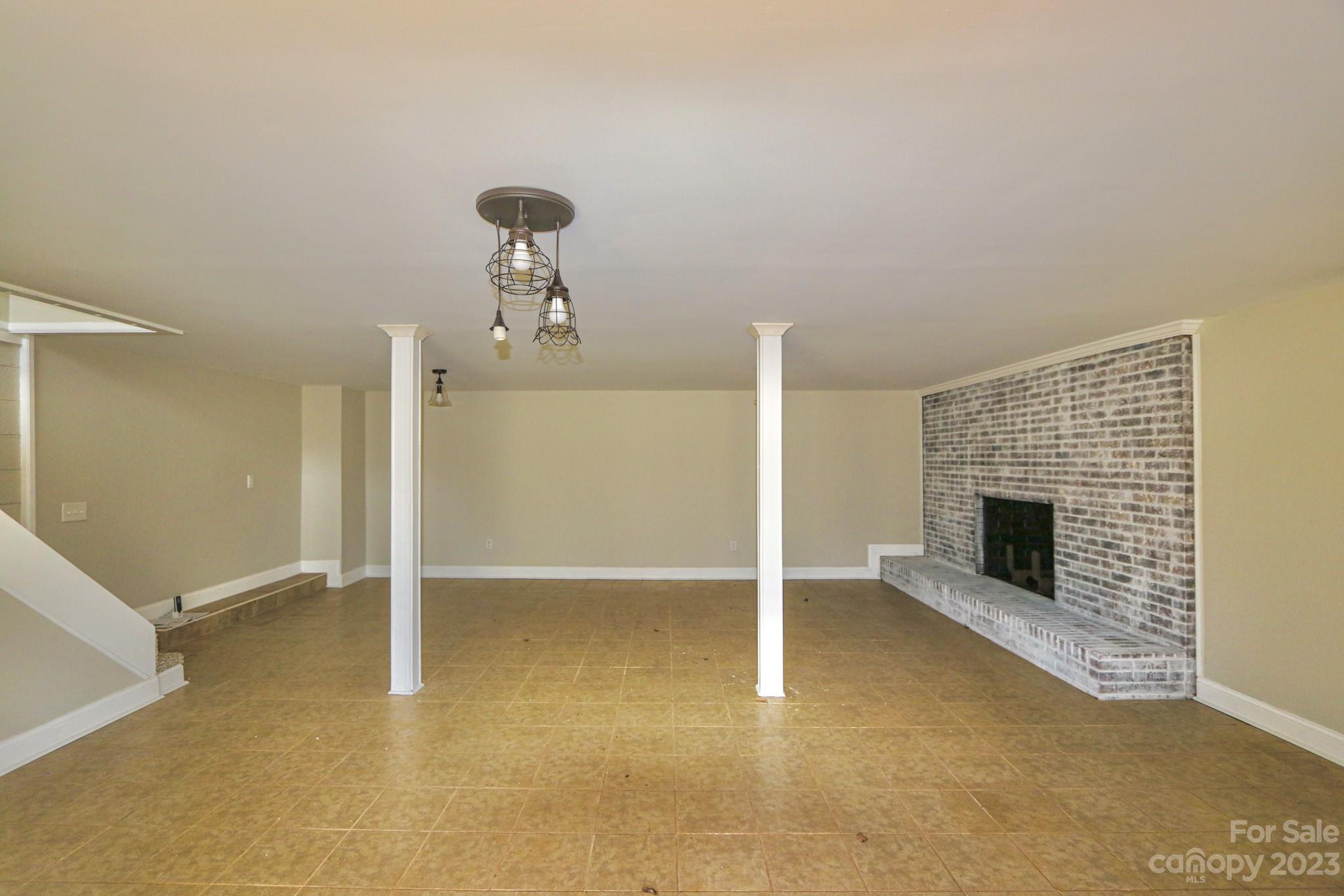 219 Harris Avenue Elkin, NC 28621 - Photo 35 of 48 an empty room with fireplace and windows