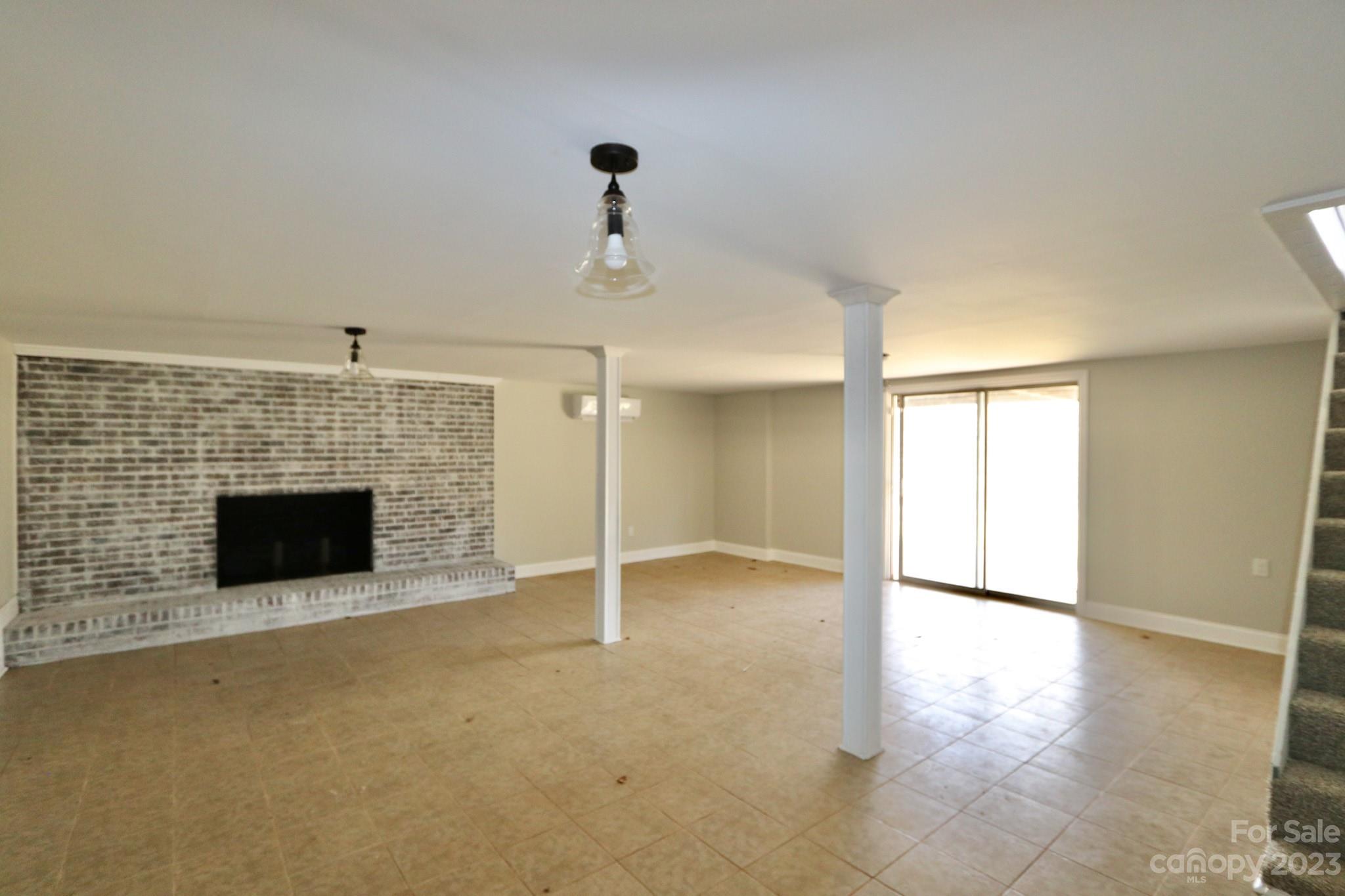 219 Harris Avenue Elkin, NC 28621 - Photo 36 of 48 an empty room with windows and fireplace