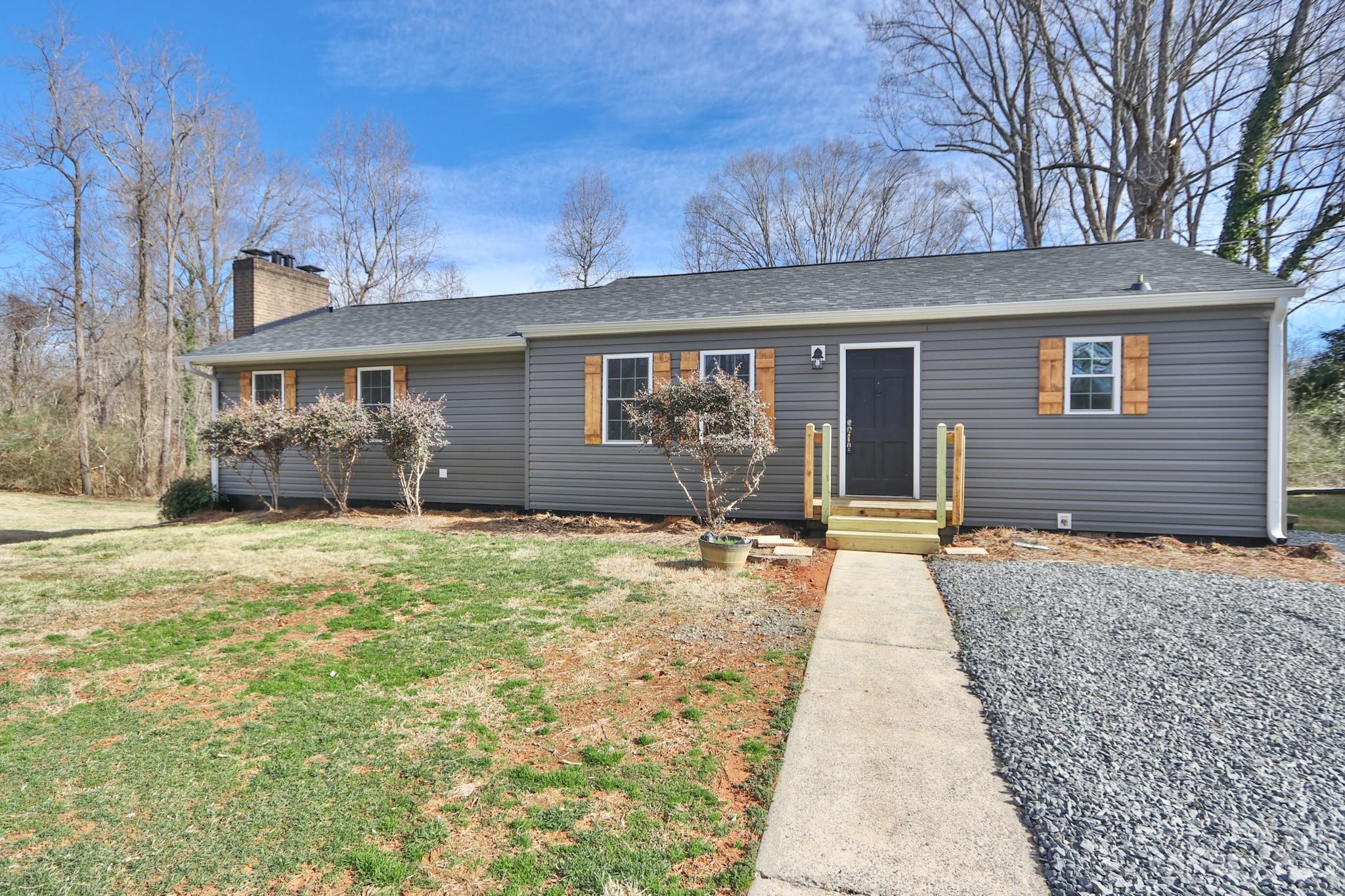 219 Harris Avenue Elkin, NC 28621 - Photo 4 of 48 a front view of a house with garden
