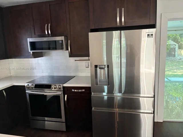 a kitchen with a stove and a refrigerator