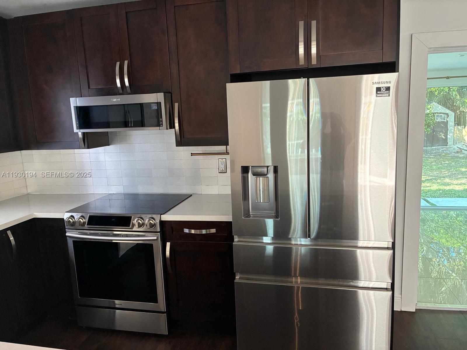 1757 Southwest 24th Terrace Miami, FL 33145 - Photo 12 of 40 a kitchen with a stove and a refrigerator