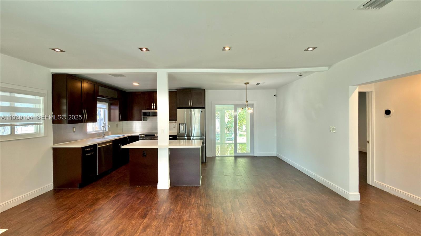 1757 Southwest 24th Terrace Miami, FL 33145 - Photo 12 of 37 a large kitchen with wooden floor and stainless steel appliances