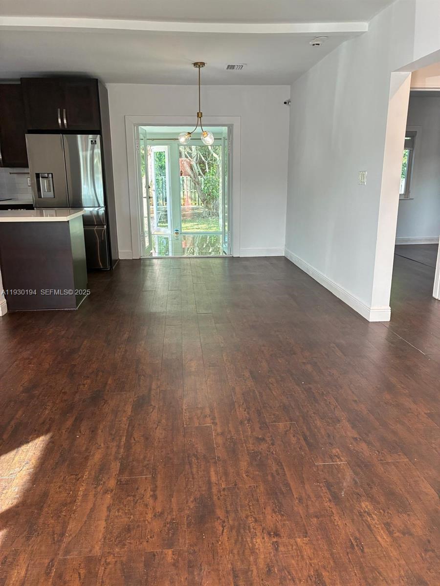 1757 Southwest 24th Terrace Miami, FL 33145 - Photo 13 of 40 an empty room with wooden floor and window