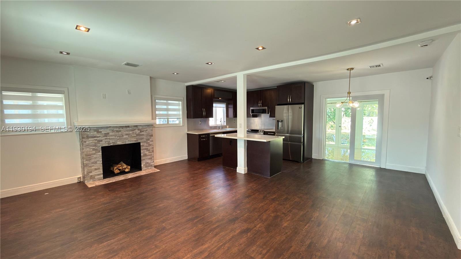 1757 Southwest 24th Terrace Miami, FL 33145 - Photo 13 of 37 a open kitchen with wooden floors and fireplace