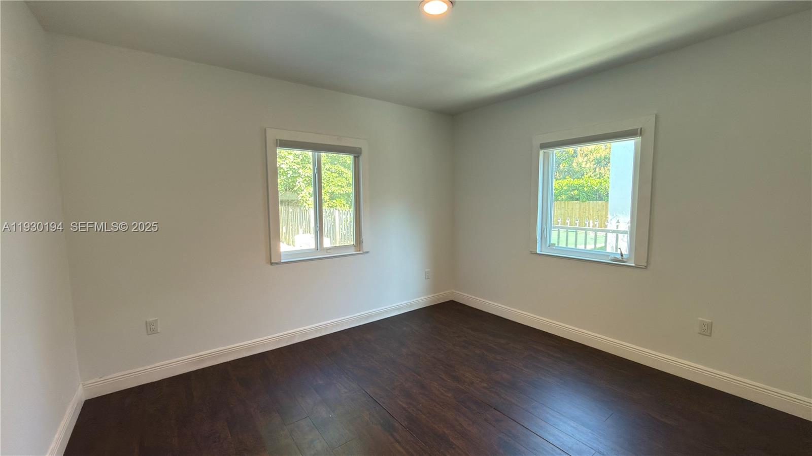 1757 Southwest 24th Terrace Miami, FL 33145 - Photo 19 of 37 a view of a room with wooden floor and windows