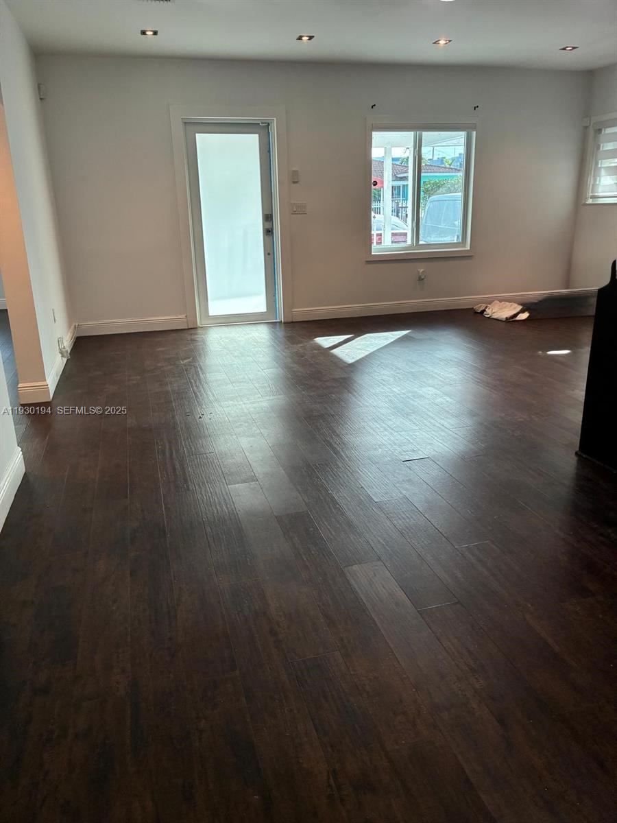 1757 Southwest 24th Terrace Miami, FL 33145 - Photo 20 of 40 an empty room with wooden floor and windows