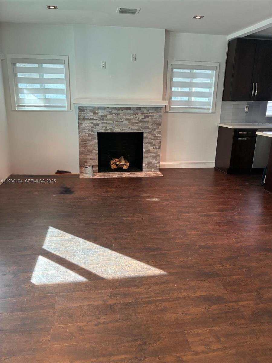 1757 Southwest 24th Terrace Miami, FL 33145 - Photo 21 of 40 a view of empty room with wooden floor and fireplace