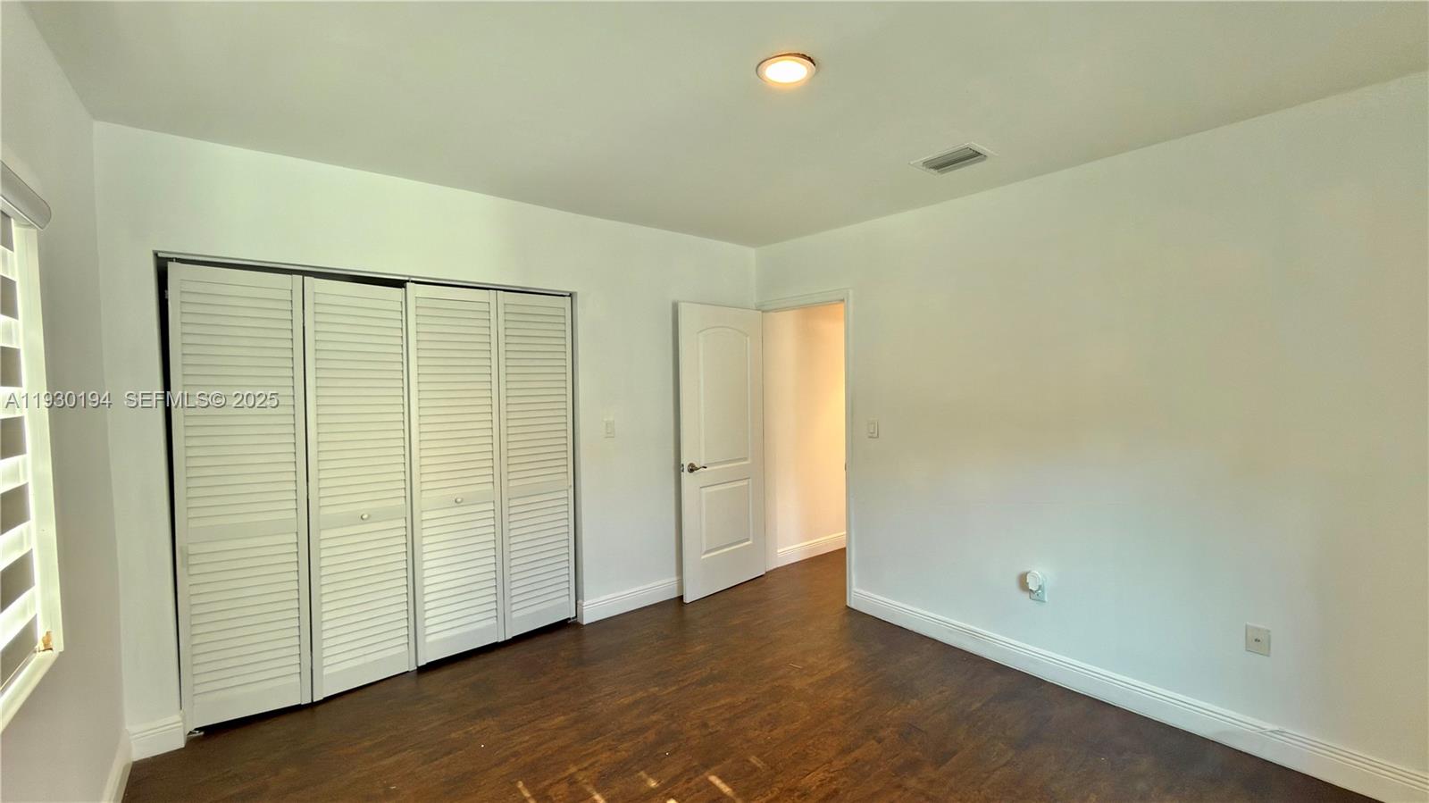 1757 Southwest 24th Terrace Miami, FL 33145 - Photo 21 of 37 an empty room with wooden floor and natural light