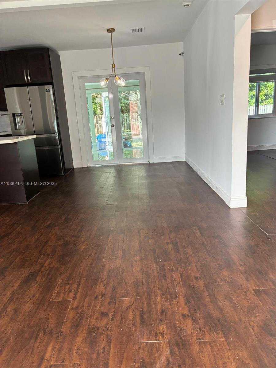 1757 Southwest 24th Terrace Miami, FL 33145 - Photo 22 of 40 an empty room with wooden floor and windows