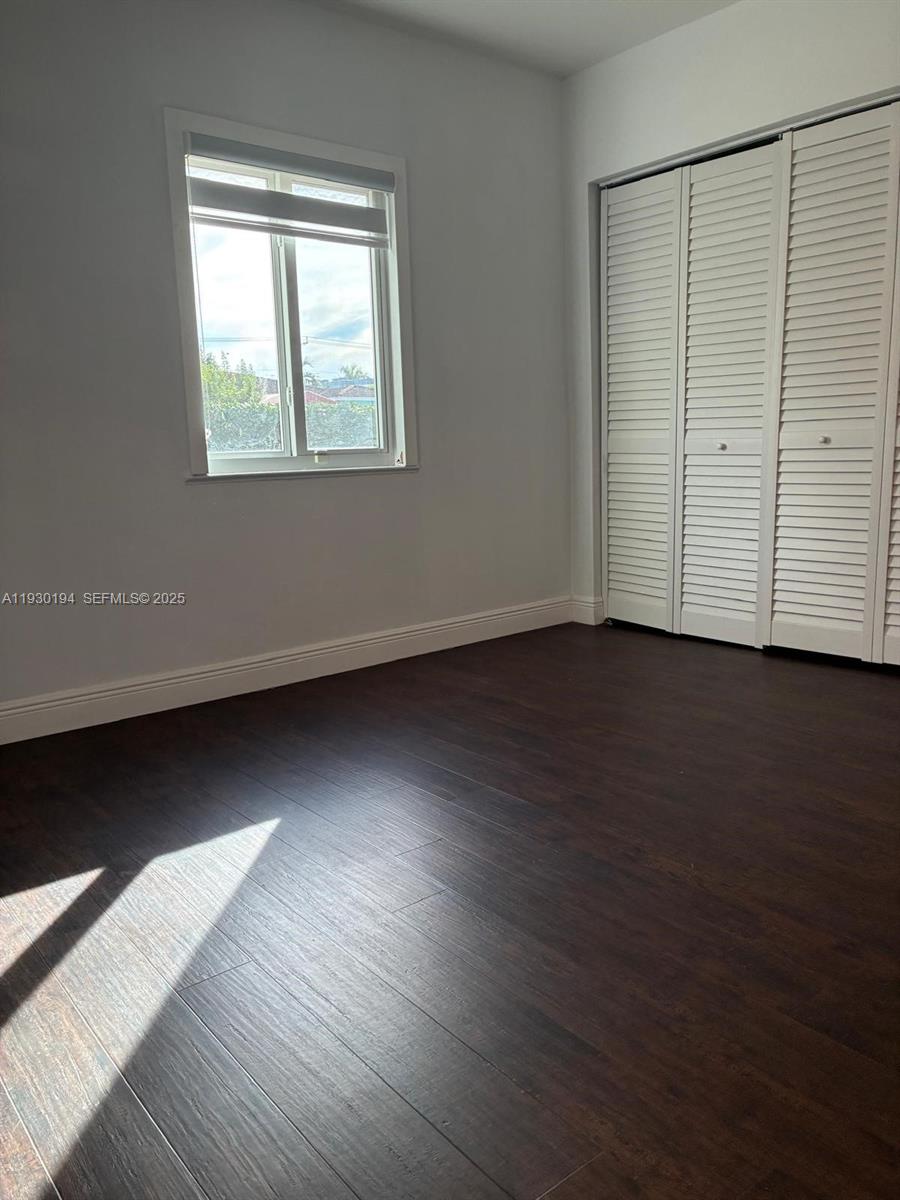 1757 Southwest 24th Terrace Miami, FL 33145 - Photo 23 of 40 an empty room with wooden floor and windows