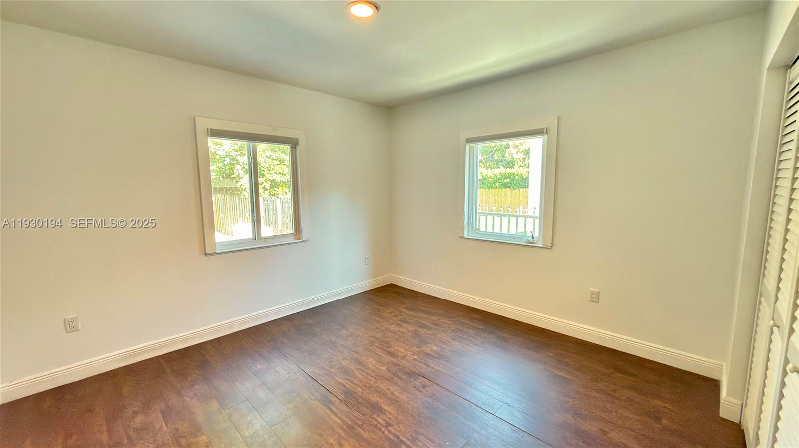 1757 Southwest 24th Terrace Miami, FL 33145 - Photo 24 of 37 an empty room with wooden floor and windows