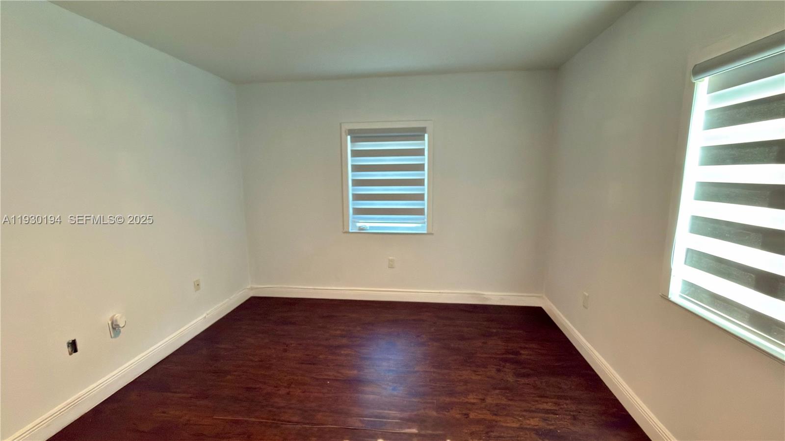 1757 Southwest 24th Terrace Miami, FL 33145 - Photo 26 of 37 wooden floor in an empty room with a window