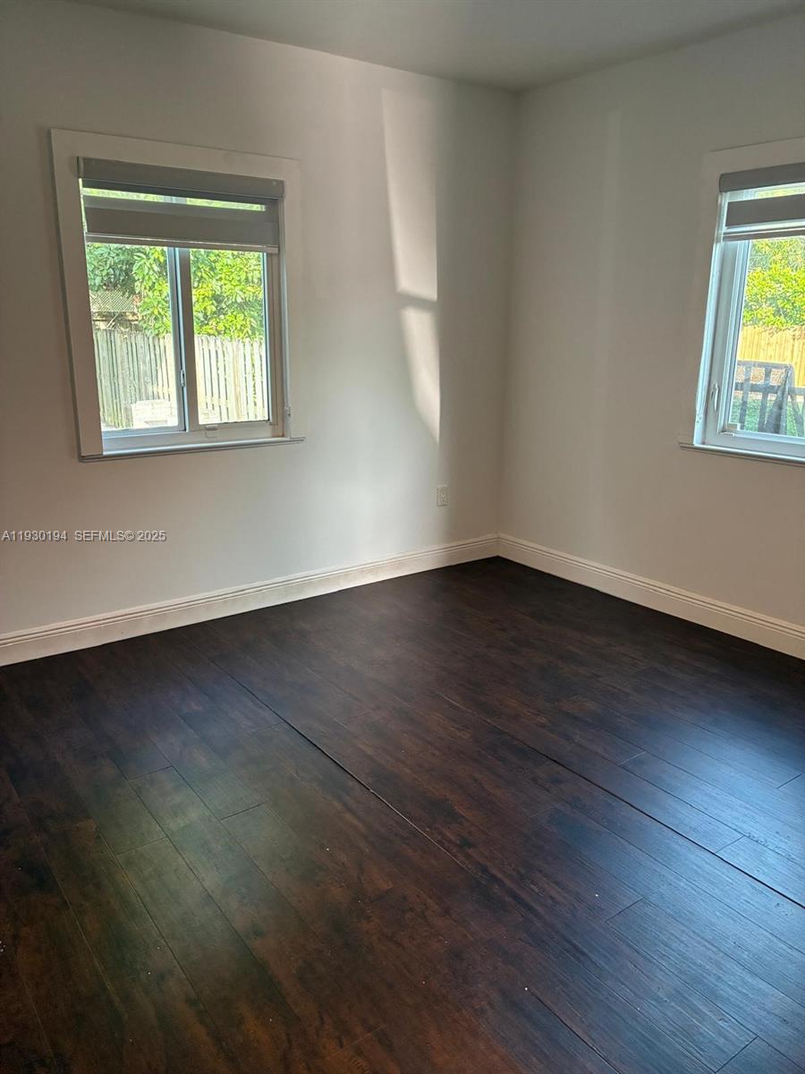 1757 Southwest 24th Terrace Miami, FL 33145 - Photo 30 of 40 a view of an empty room with wooden floor and a window