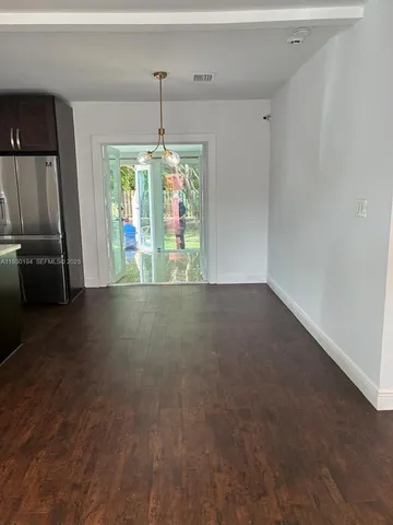a view of room with window and chandelier