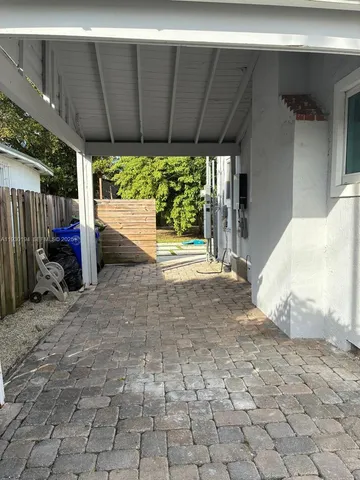a view of a backyard with wooden fence