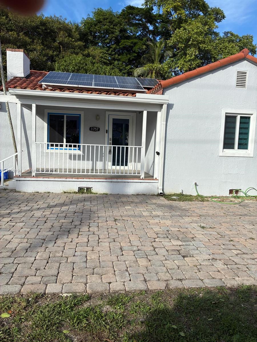 1757 Southwest 24th Terrace Miami, FL 33145 - Photo 4 of 40 a front view of a house with a yard