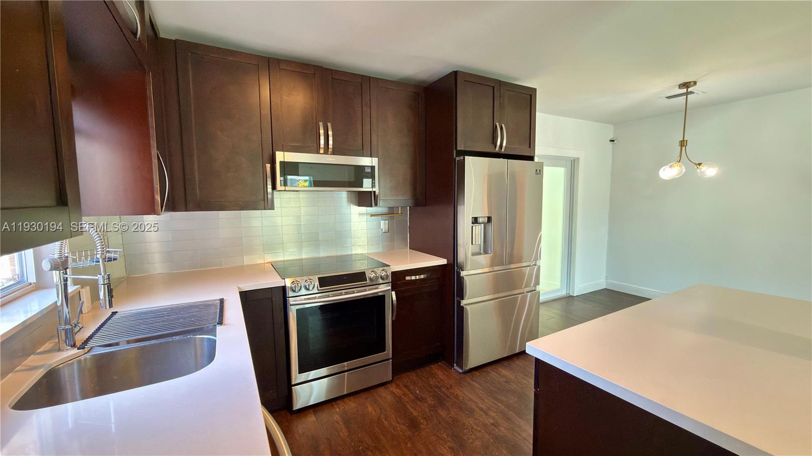 1757 Southwest 24th Terrace Miami, FL 33145 - Photo 8 of 37 a kitchen with stainless steel appliances granite countertop a refrigerator stove and sink