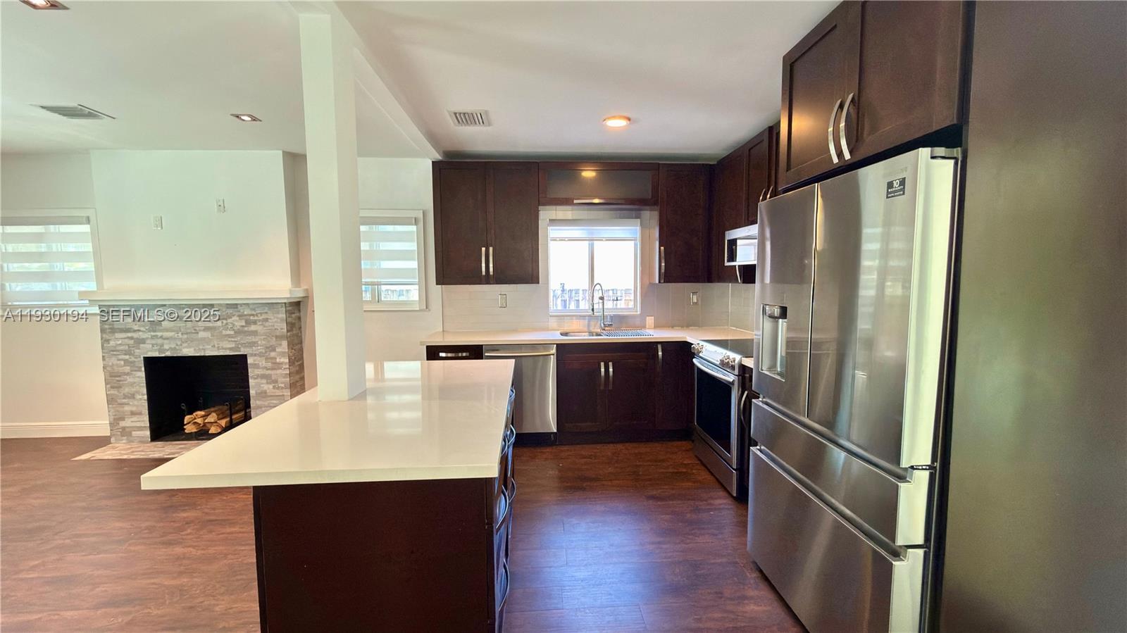 1757 Southwest 24th Terrace Miami, FL 33145 - Photo 9 of 37 a kitchen with kitchen island a counter top space a refrigerator a sink and a stove