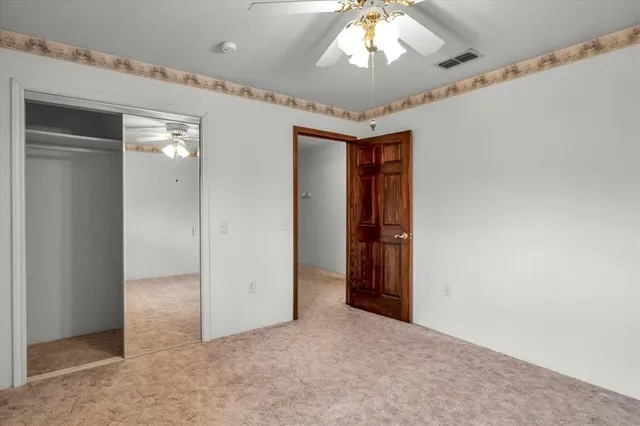 a view of a livingroom with a chandelier fan