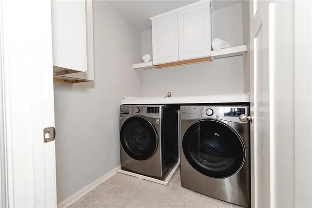 a backyard of a house with barbeque oven table and chairs