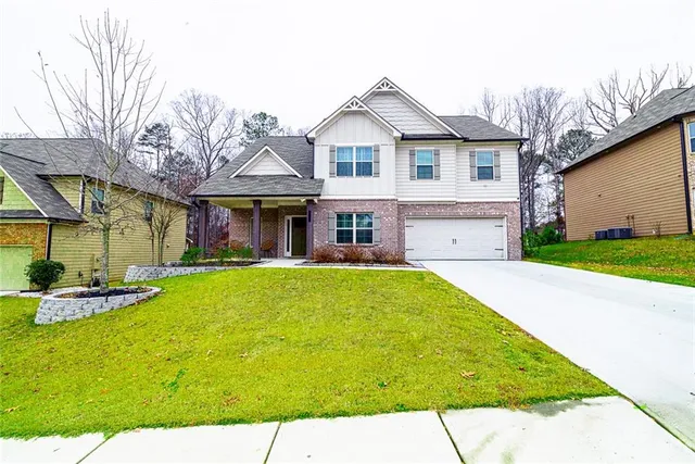a front view of a house with a yard table and chairs