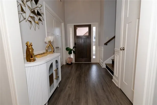 a dining room with stainless steel appliances kitchen island granite countertop a table chairs refrigerator and microwave