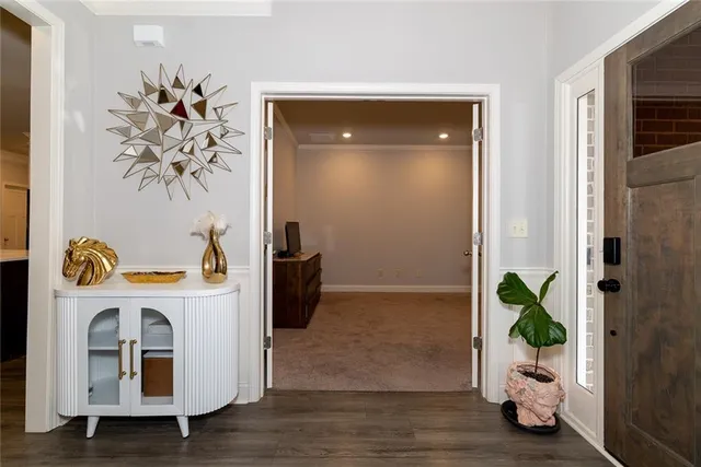 a living room with stainless steel appliances kitchen island granite countertop furniture a refrigerator a stove top oven a sink and a center island